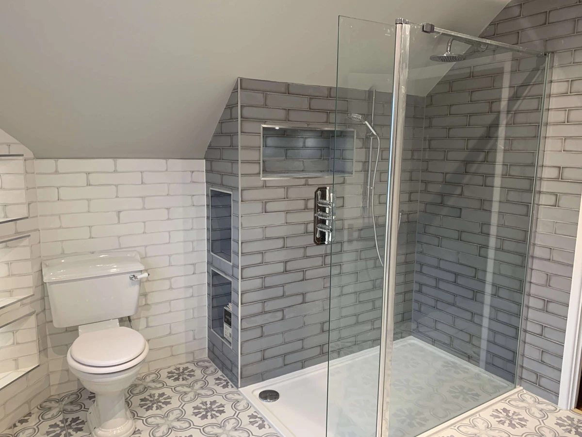 A white toilet sitting next to a walk in shower.